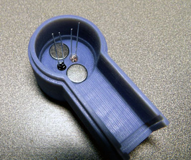 ANSI T2 opto-coupler showing magnets, LED and Photodiode installed